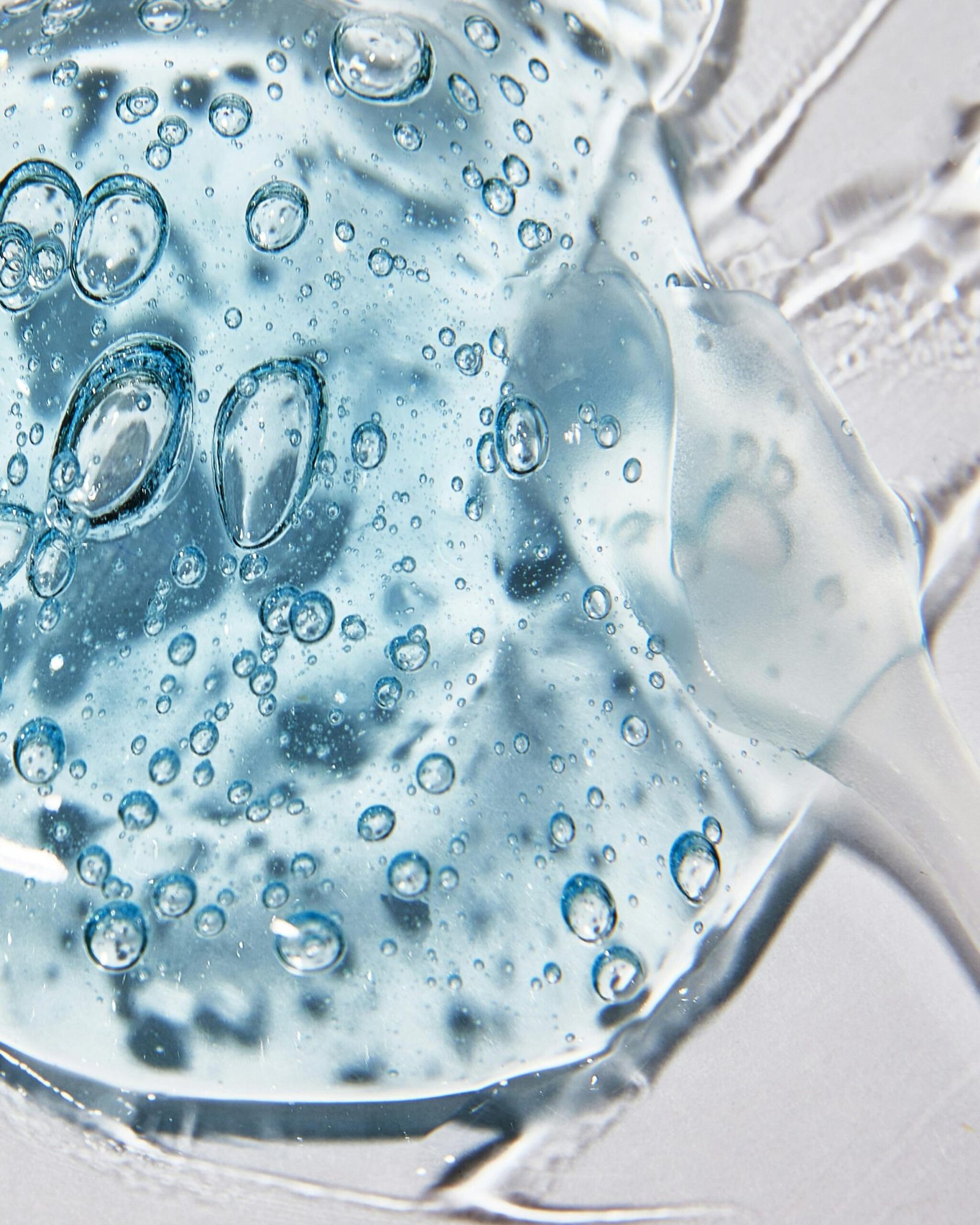 Macro shot of clear cosmetic gel with air bubbles showing texture and clarity.